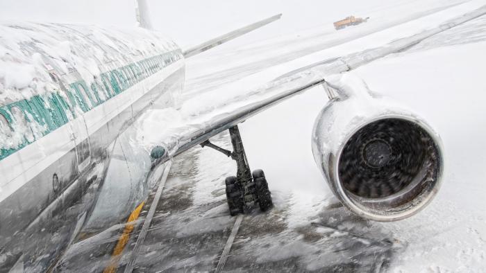 close up of a commercial plane with snow and ice