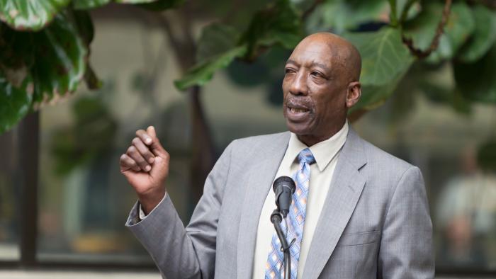 Booker Brown speaking at a podium