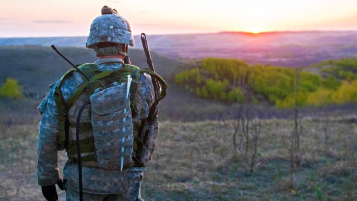 Soldier outside facing the sunset