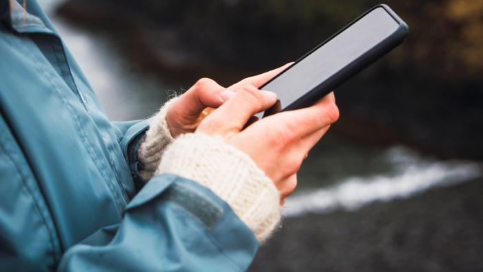 Hands of a woman holding a smartphone