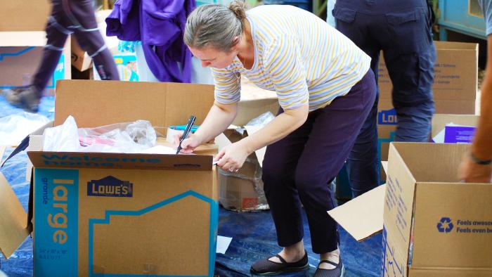 Tanya Wynn writing on a cardboard box