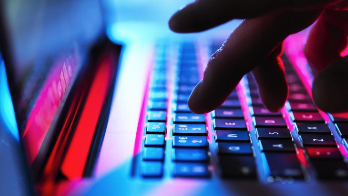 Close-up photo of someone typing on a keyboard