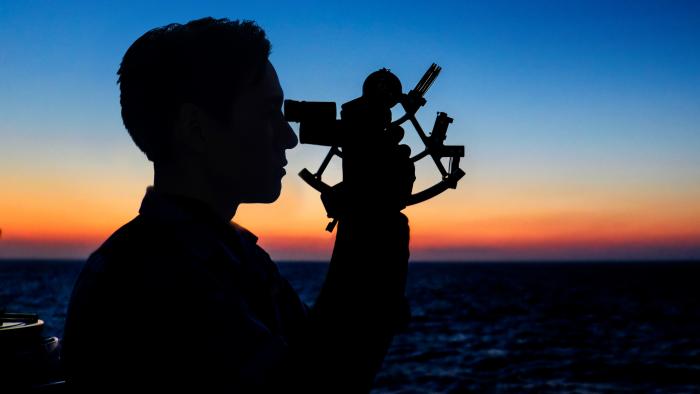 Man looking through sextant