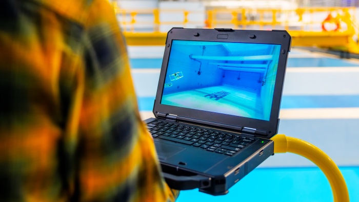 Employee holding a laptop in the BlueTech lab