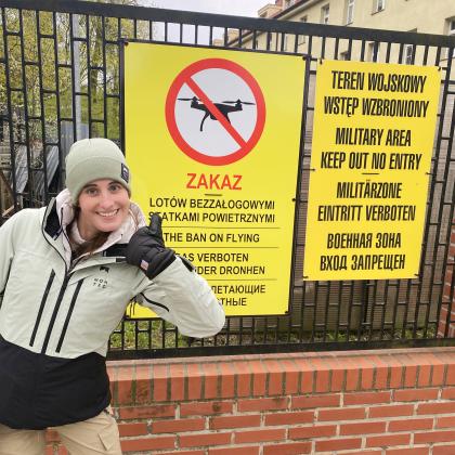 Hannah in front of drone signs