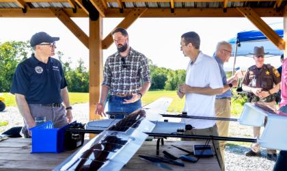 Stakeholders talking in front of a drone