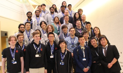 A large group of students standing on stairs posing for a picture