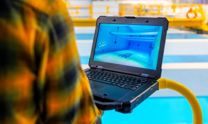 Employee holding a laptop in the BlueTech lab