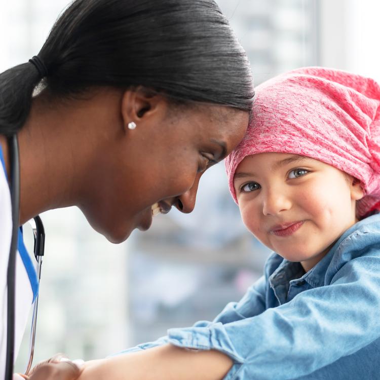 Female doctor comforts her young patient who has cancer