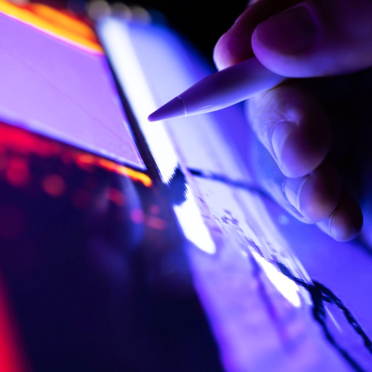 Person writing on a tablet with a digital pen