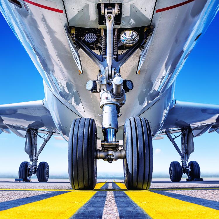 Plane on a runway with view of its landing gear