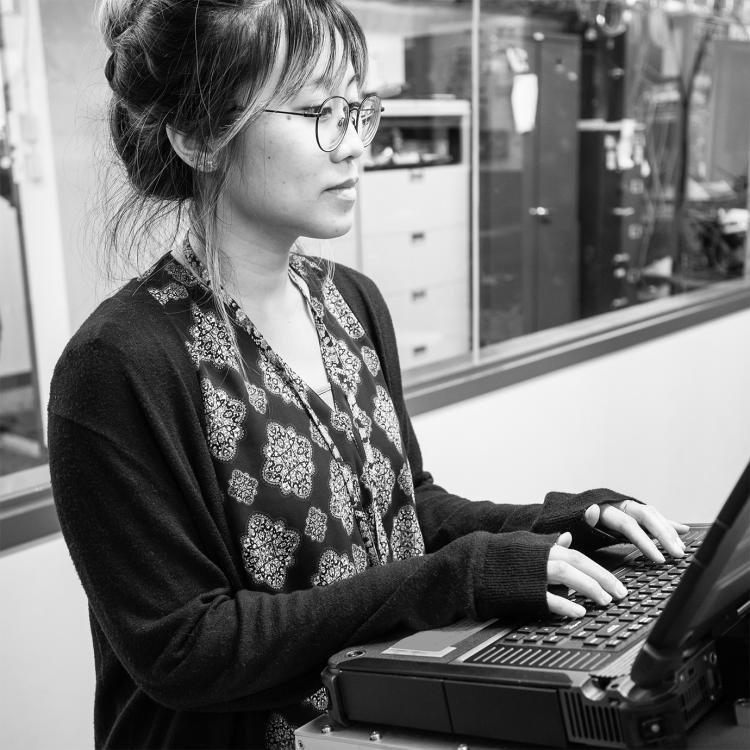 Employee typing on a laptop in the lab