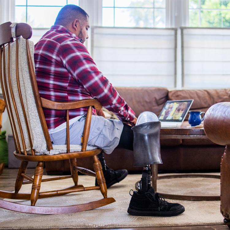 Veteran amputee has a telemedicine call with doctors