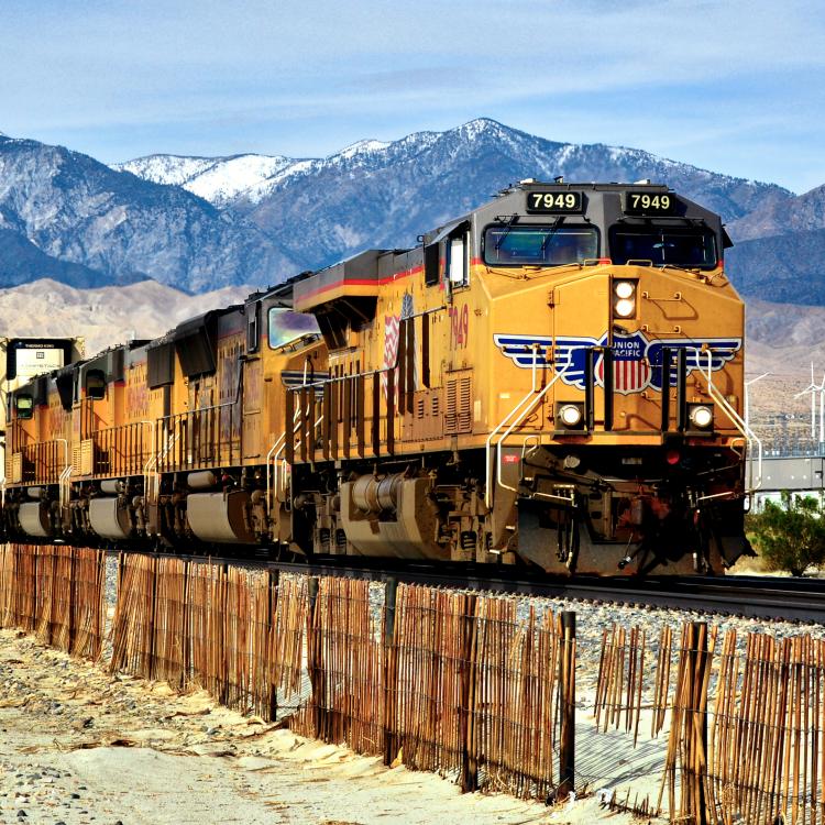 train in front of mountains