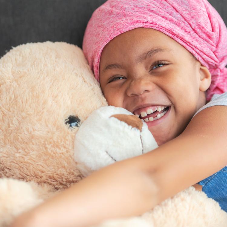 girl hugging a teddy bear